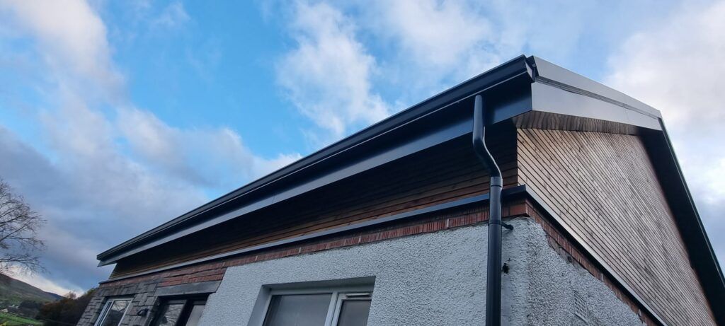Long seamless gutter run against a blue sky